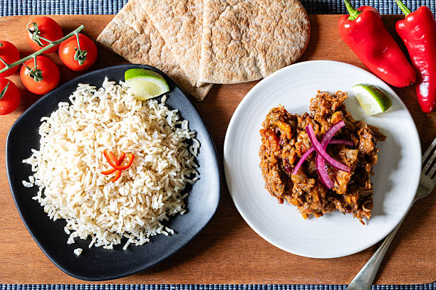 istock Home cooked chilli dish with rice on a wooden board 2218262754