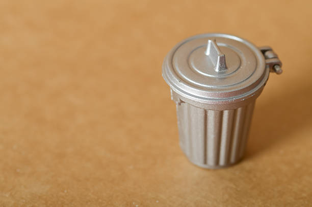Delete data or spam mail concept. Trash can. Four white arrows pointing at a yellow button with a delete symbol on a yellow background.