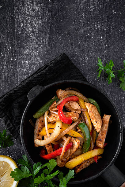 istock Chicken Fajitas on a rustic background 2218263413