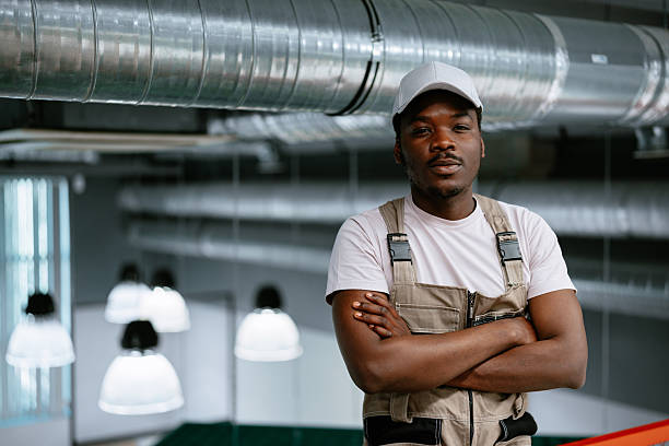 istock Skilled worker posing confidently in a modern industrial workspace during daytime 2218265278