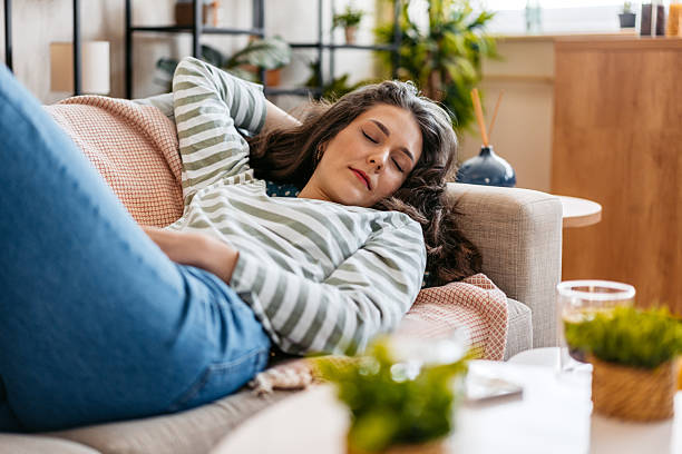 Young Woman Sleeping On The Sofa At Home