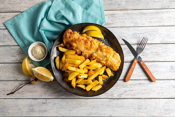 istock Delicious Golden Fish and Chips Served With Lemons 2218267057