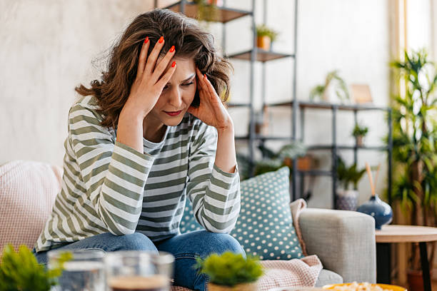 istock Sad Young Woman Sitting At Home On The Sofa 2218267300