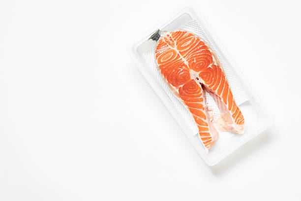Salmon in plastic packaging on white background, chilled fish