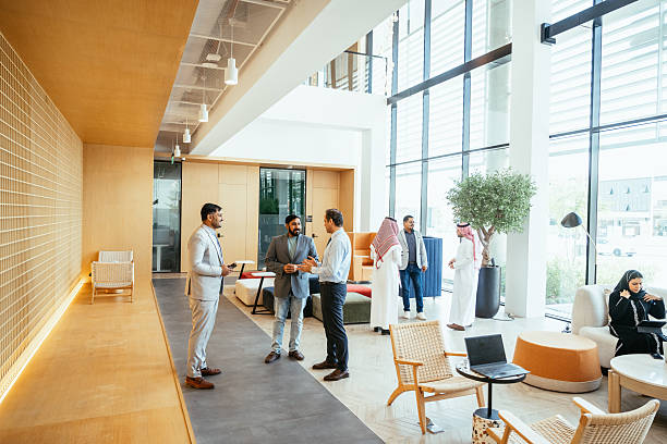 istock Middle Eastern business people having conversation in modern lobby after business conference 2218273309