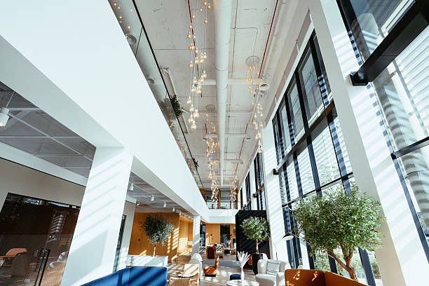 istock Modern and inviting office lobby with large windows, elegant lighting, plants, and stylish furniture creating a welcoming atmosphere 2218273689