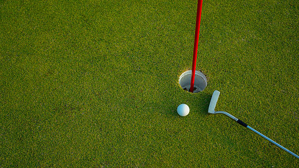 istock Golf hole on a green grass in the evening golf course with sunshine background. 2218275017
