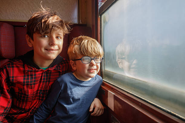 istock Two brothers in carriage point and talk over the window frame 2218275992