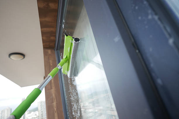 istock Window cleaning with a squeegee on a sunny day in the city 2218276749