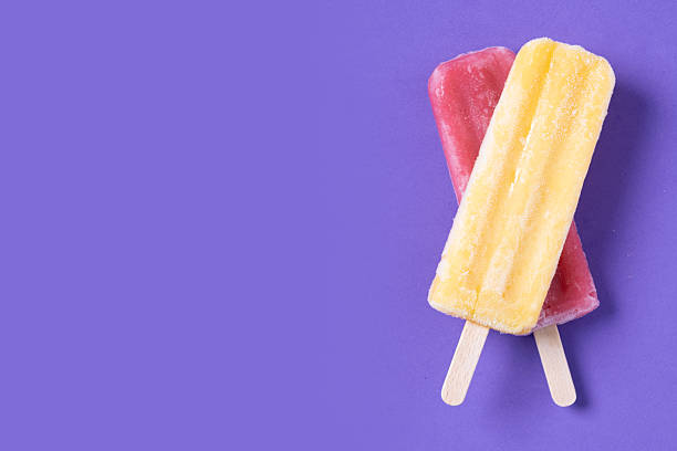 Red and yellow popsicles pattern on purple background