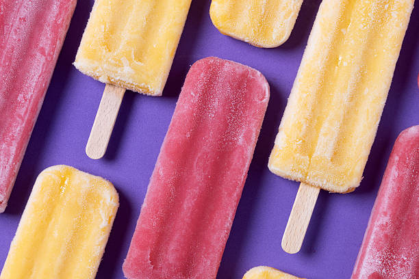 istock Red strawberry popsicles and yellow popsicles 2218276875