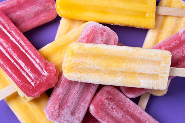 istock Red strawberry popsicles and yellow popsicles 2218276923
