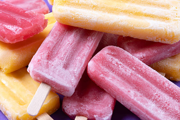 istock Red strawberry popsicles and yellow popsicles 2218276958