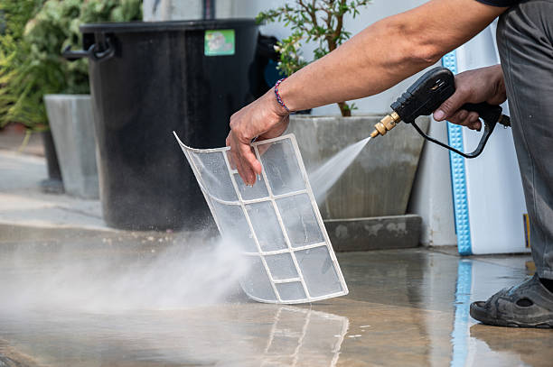istock Technician using high pressure water gun for cleaning air conditioner filters. 2218278161