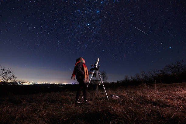 istock Amateur astronomer using telescope for watching stars, Moon, planets and other celestial objects from a field in nature. 2218281587