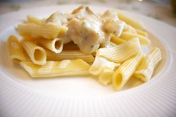 istock Penne pasta with carbonara sauce on white plate 2218281629