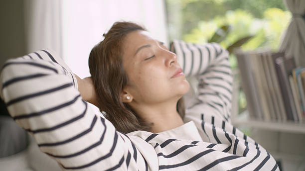 istock Asian Woman Stretching While Working on Laptop – Office Break Moment. 4k 2218282110
