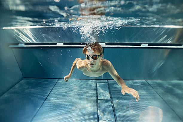 istock Underwater swimmer gliding effortlessly in water. 2218283775