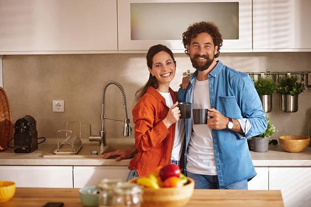 istock Happy couple drinking coffee in modern kitchen 2218291435