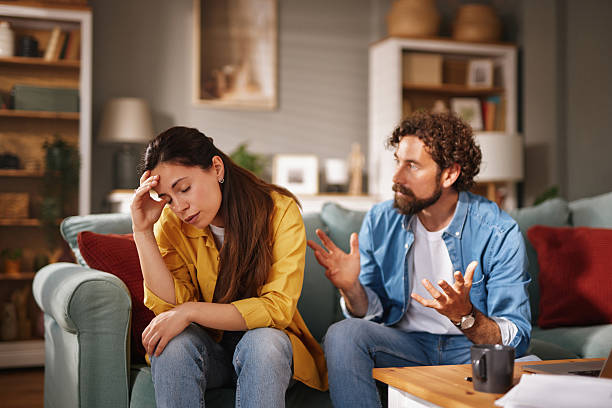 istock Frustrated man arguing with sad woman at home on sofa 2218291689