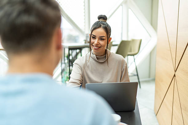 istock Young business partners discussing a project using a laptop in a modern office 2218291760
