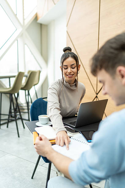 istock Young colleagues collaborating on project in modern office cafe 2218291860