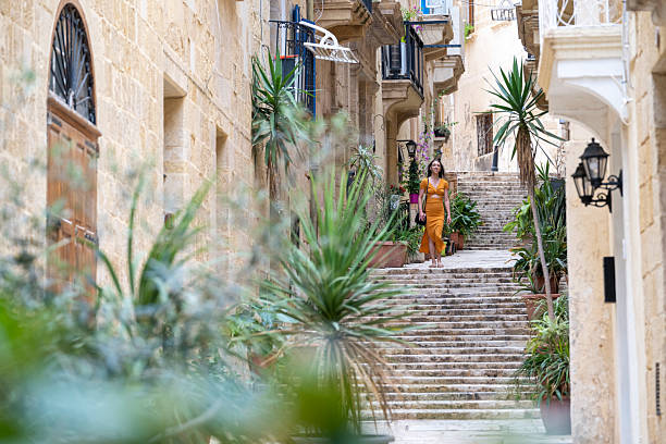 istock Woman walks steps in old town, Valetta 2218292382