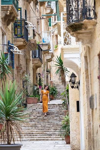 istock Woman walks steps in old town, Valetta 2218292434