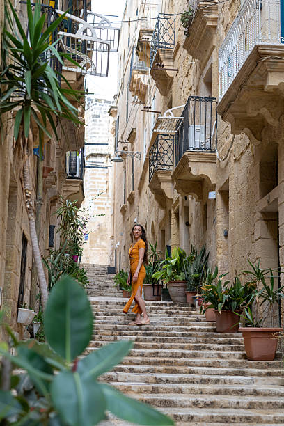istock Woman walks steps in old town, Valetta 2218292436