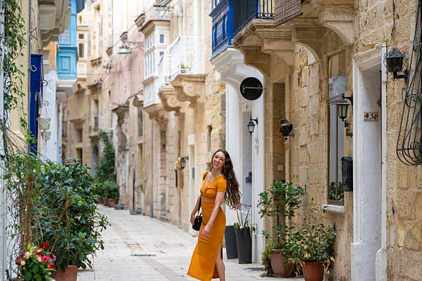 Woman explores narrow streets, Birgu, Valetta