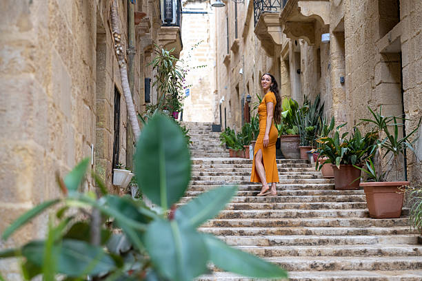 istock Woman walks steps in old town, Valetta 2218292519