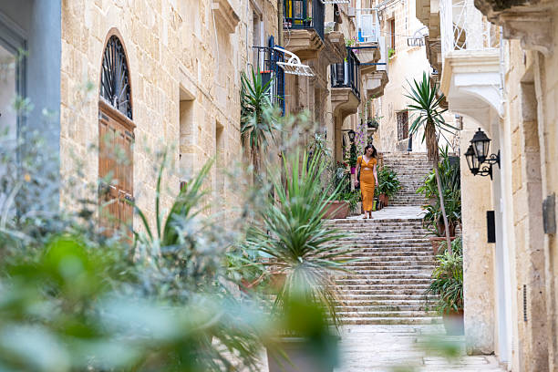 istock Woman walks steps in old town, Valetta 2218292685