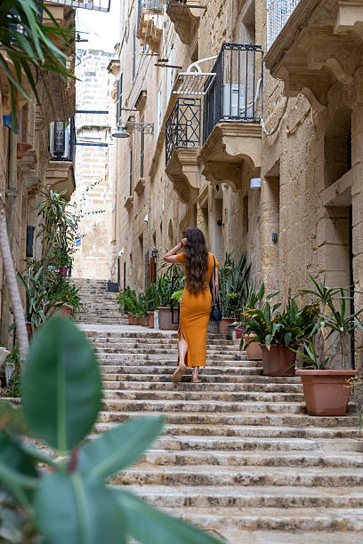 istock Woman walks steps in old town, Valetta 2218292686