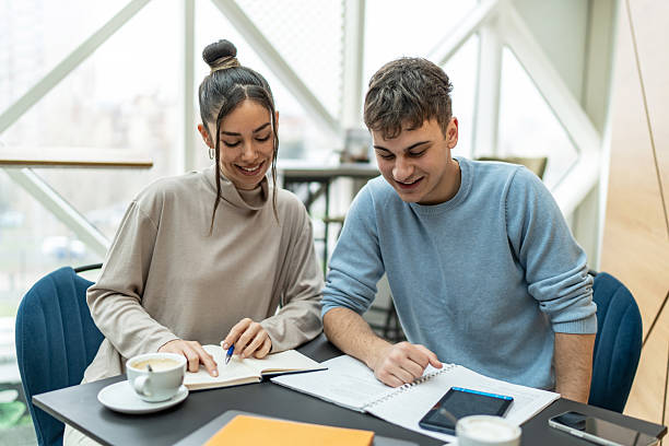 istock Two young adults students collaborating on a project in university cafeteria 2218292757