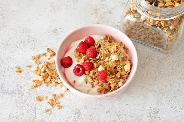 istock Delicious Granola and Yogurt Breakfast with Fresh Raspberries table top view 2218292869
