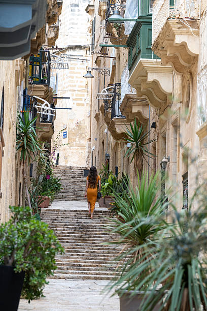 istock Woman walks steps in old town, Valetta 2218292871