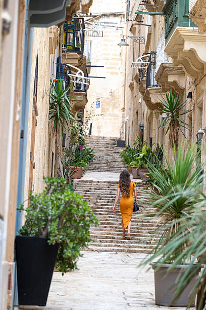istock Woman walks steps in old town, Valetta 2218292875
