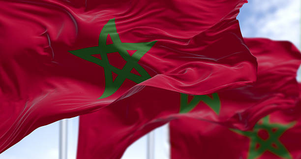 Morocco national flags waving in the wind on a clear day. Red flags with a green pentagram in the center. 3d illustration render. Selective focus. Waving flag