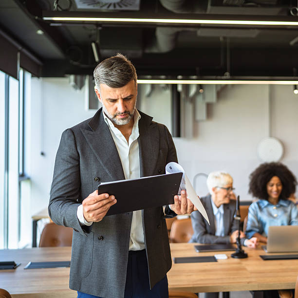 istock focused businessman executive stand in office and analysis document 2218305092