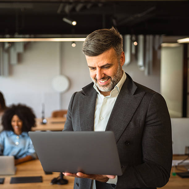 istock focused businessman executive stand in office and use laptop 2218305334