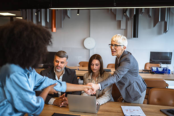 istock multicultural colleagues handshaking on the meeting in office 2218306639