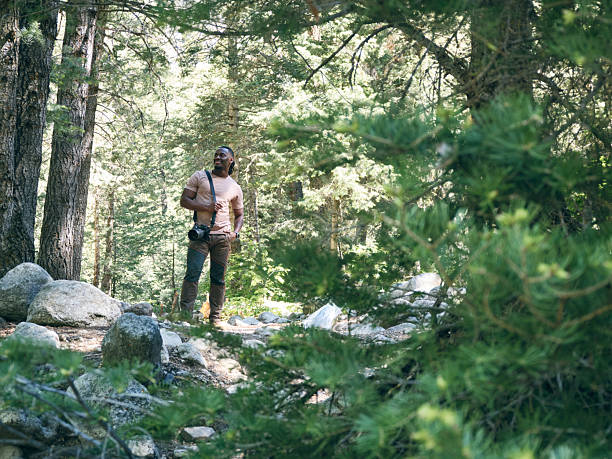 A young man on a hike in a forest. Utah, USA.