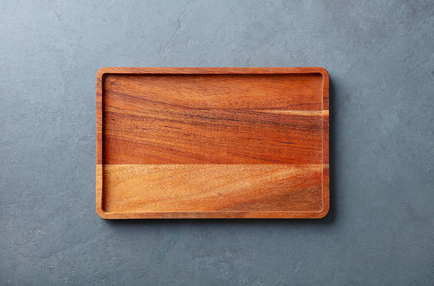istock Wooden cutting board or serving board, top view. Copy space for design elements or text. Grey stone background. Close up. 2218309665