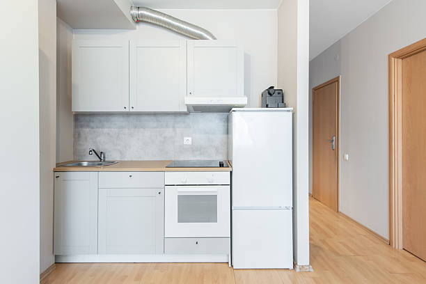 istock Modern Minimalist Kitchen Interior with White Cabinets and Wooden Flooring 2218311276