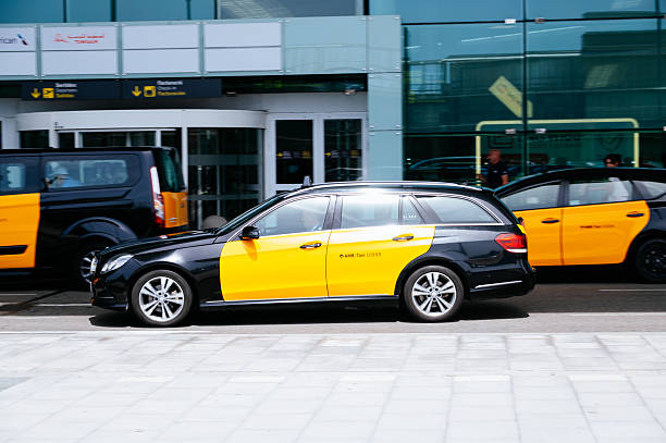 Barcelona Airport, Spain - 19 May, 2025: Barcelona taxi cars in front of the airport terminal building