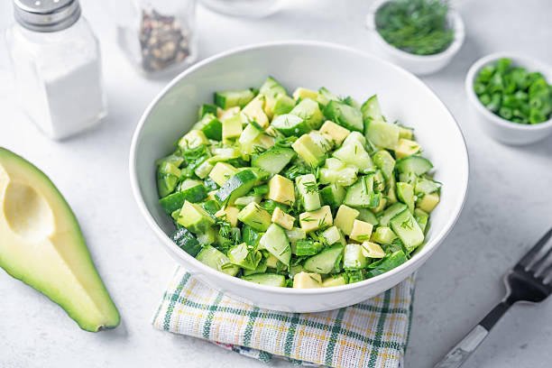 Avocado cucumber salad in a bowl stock photo