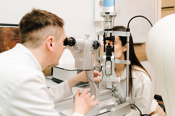 istock Slit lamp eye and cornea diagnostic at visiting ophthalmology clinic. Light on eye from slit lamp for examination eyes and cornea of girl. 2218318608