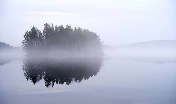 istock Misty Lake with Reflective Island 2218322584
