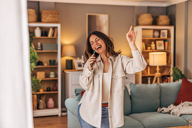 Portrait of Fashionable Young Woman Enjoy Singing Using Microphone