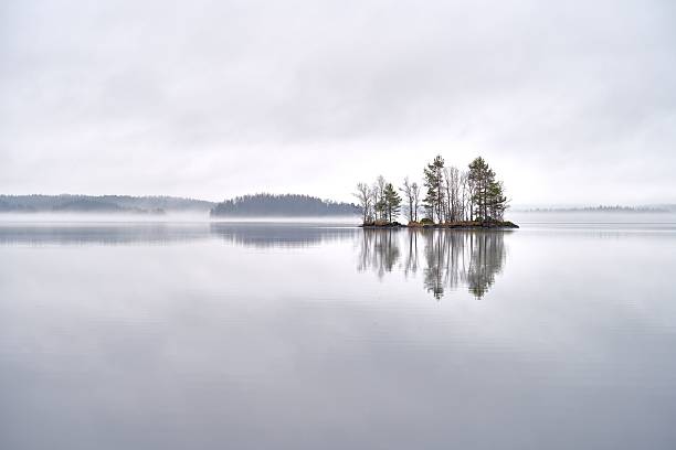 istock Misty Lake with Reflective Island 2218322598